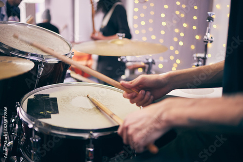Drummer and hands at event with drums for band as musician in playing an instrument. Person, party and percussion as creative for entertainment, song or lyrics for online content or live performance photo