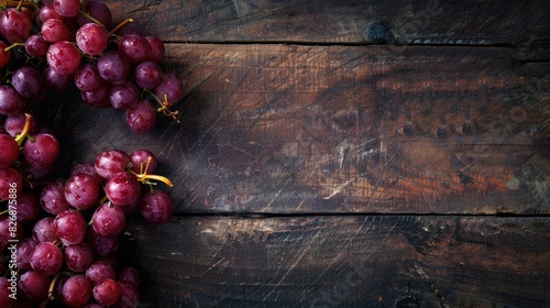 Red grapes displayed on a dark wooden surface