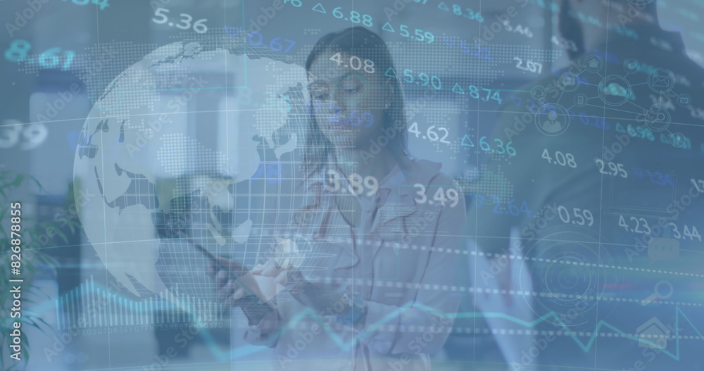 Image of stock market data processing and globe over diverse man and woman discussing at office Image of stock market data processing and globe over diverse man and woman discussing at office