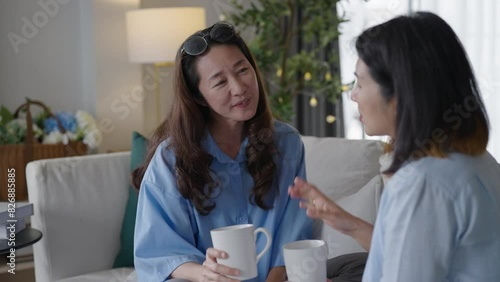 Asian middle aged woman chatting while drinking coffee and tea. friendship concept