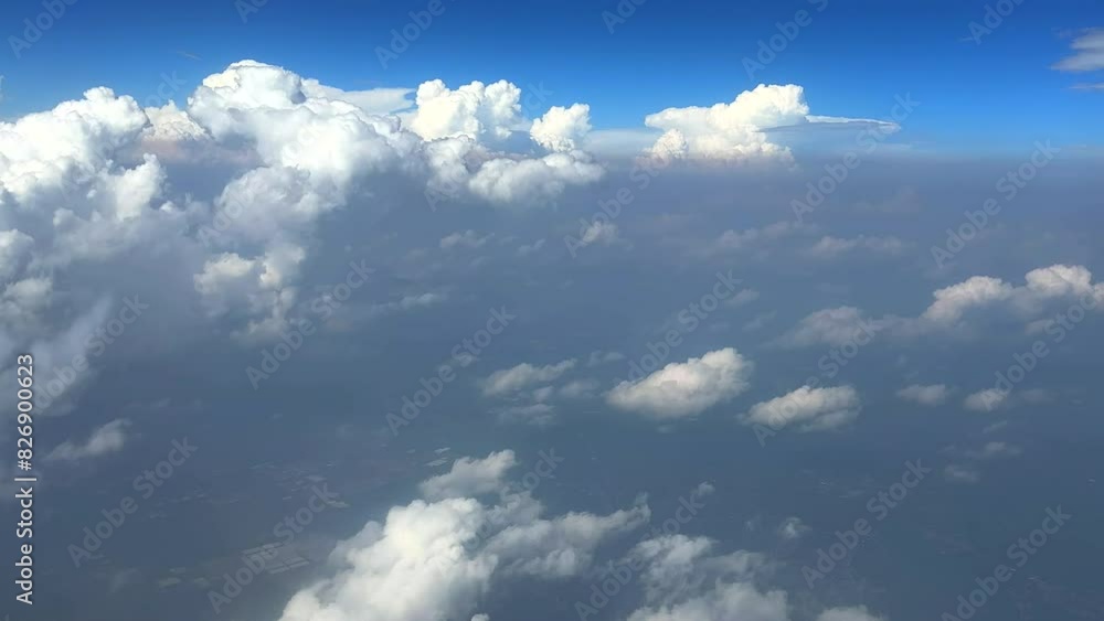Cloudscape view from plane window. View of blue sky and white clouds from airplane window. Plane flying through clouds. Plane window view of blue sky with clouds moving past. Cloudscape view from plane window. View of blue sky and white clouds from airplane window. Plane flying through clouds. Plane window view of blue sky with clouds moving past.