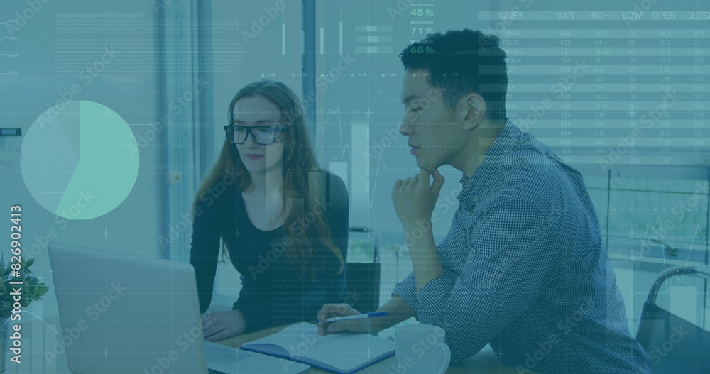 Image of statistical data processing over diverse man and woman discussing over laptop at office Image of statistical data processing over diverse man and woman discussing over laptop at office