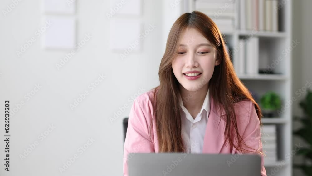Attractive Asian businesswoman, she is happy working with laptop and doing paperwork in office. Attractive Asian businesswoman, she is happy working with laptop and doing paperwork in office.