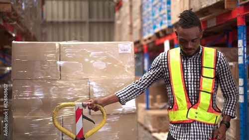 American - African ethnicity warehouse worker is working in the distribution warehouse