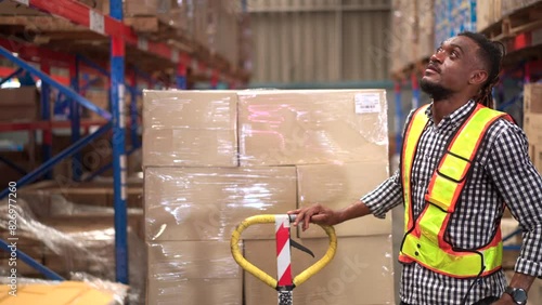 American - African ethnicity warehouse worker is working in the distribution warehouse
