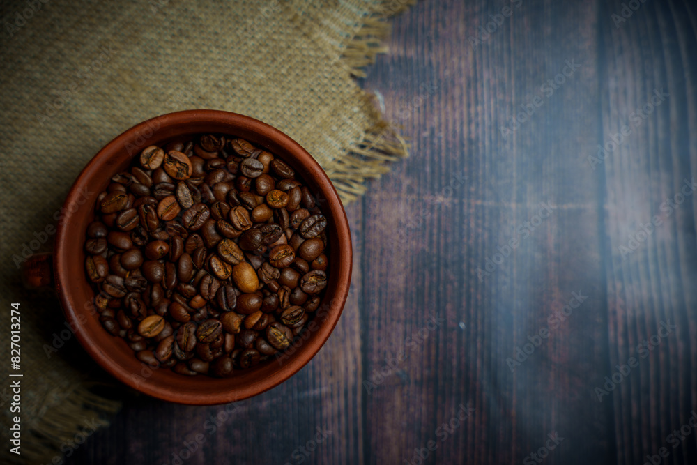 Coffee beans in a clay mug