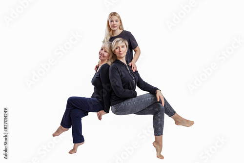 Several generations of women in black clothes sit nearby. Love and tenderness in the family. Isolated on a white background.