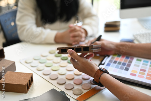 Interior designers working with furniture material samples at co working space in office photo