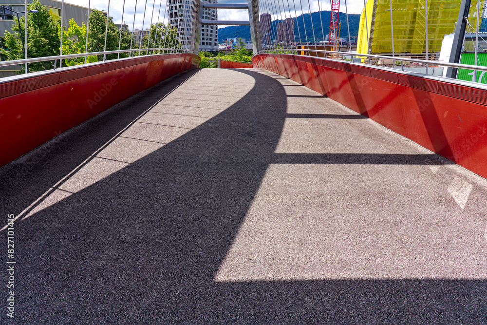 Footbridge with arc and shadow at industrial district at Swiss City of Zürich on a blue cloudy spring day. Photo taken May 24th, 2024, Zurich, Switzerland. Footbridge with arc and shadow at industrial district at Swiss City of Zürich on a blue cloudy spring day. Photo taken May 24th, 2024, Zurich, Switzerland.