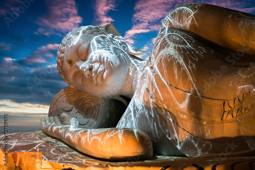 Nirvana white marble reclining Buddha, beautiful sky background.