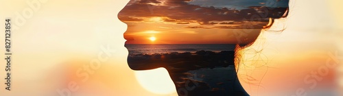 A double exposure of a woman's silhouette and sunset on the beach, symbolizing self-typicality, beauty, life balance and wellbeing in the front view. The silhouette and background are in focus with bl photo