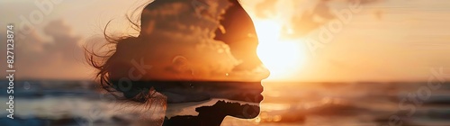 A double exposure of a woman's silhouette and sunset on the beach, symbolizing self-typicality, beauty, life balance and wellbeing in the front view. The silhouette and background are in focus with bl photo