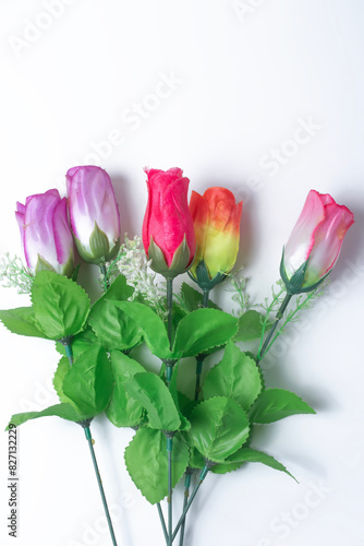 Bouquet of colorful artificial roses on white background