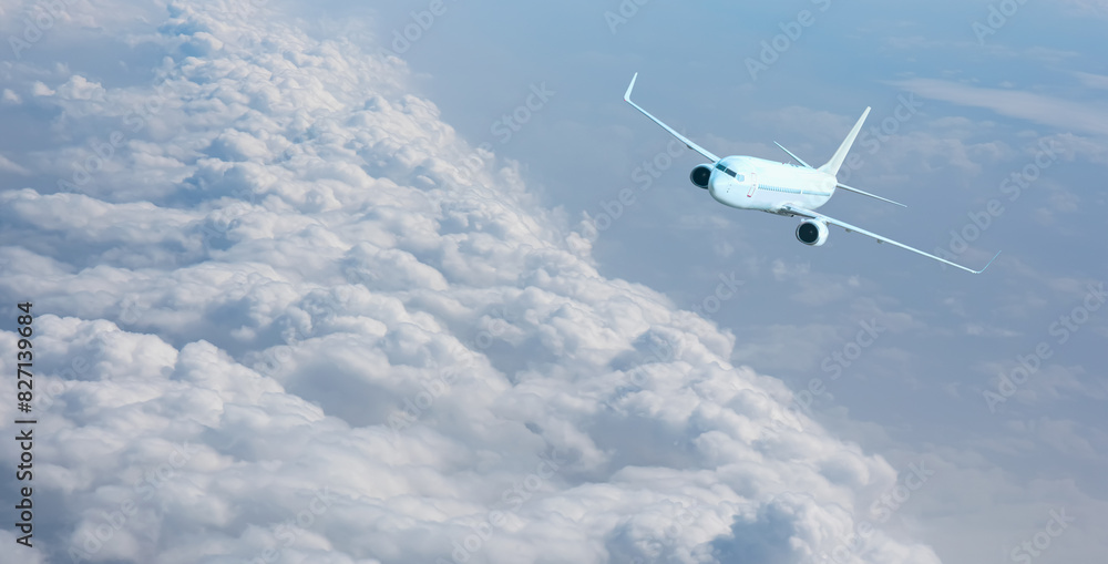 White passenger airplane flying in the sky amazing clouds in the background - Travel by air transport White passenger airplane flying in the sky amazing clouds in the background - Travel by air transport