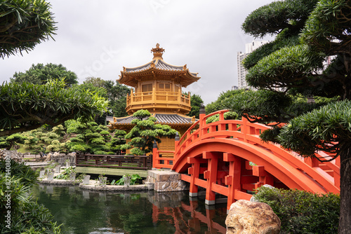 chinese pavilion in Nan Lian Garden,Hong kong.yellow chinese temple and red bridge.