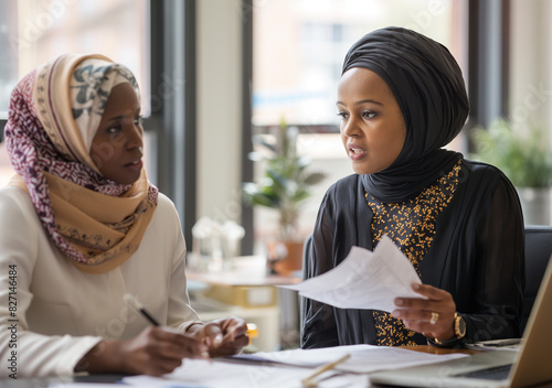 Black female lawyer providing expert legal assistance to a client in a modern office setting