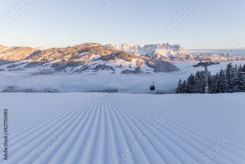 Freshly groomed ski slope with cable car in Kitzbühel, Tyrol, Austria photo
