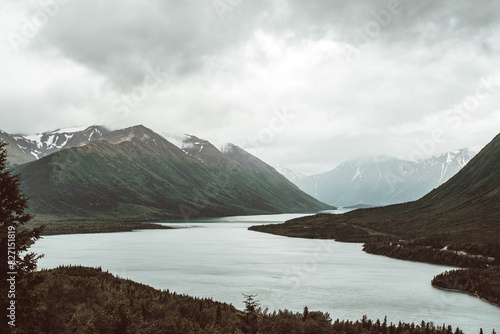 mountains with a large river running through them photo