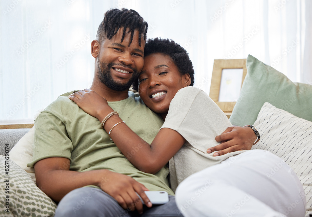 Portrait, couple and love with smile in home for commitment, marriage and happy together on sofa. Man, African woman and hug in apartment for morning, partner and romance in living room for relax Portrait, couple and love with smile in home for commitment, marriage and happy together on sofa. Man, African woman and hug in apartment for morning, partner and romance in living room for relax