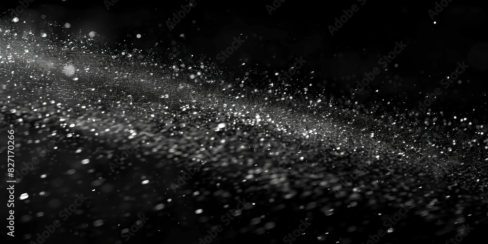 Water spray on black background, white water droplets falling in the air, particles of dust floating in space.Abstract black and white bokeh lights with sparkling particles creating a dramatic Water spray on black background, white water droplets falling in the air, particles of dust floating in space.Abstract black and white bokeh lights with sparkling particles creating a dramatic