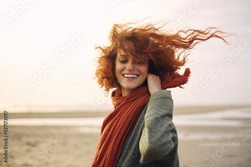 portrait of happy woman with windswept hair on the beach © alisaaa