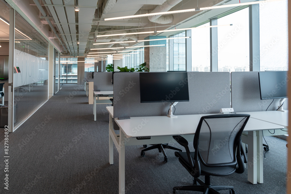 Interior of modern empty office building.Open ceiling design.Equipped with automatic lifting table and LCD screen. Interior of modern empty office building.Open ceiling design.Equipped with automatic lifting table and LCD screen.