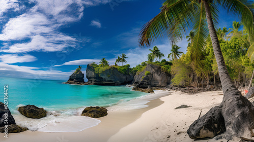 A panoramic HDR view of a secluded beach cove, with crystal-clear turquoise waters, lush green palm trees, and soft white sand, under a bright blue sky.