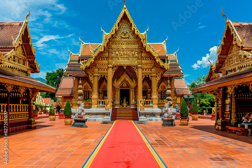 A large building with gold trim and a red carpet leading up to it