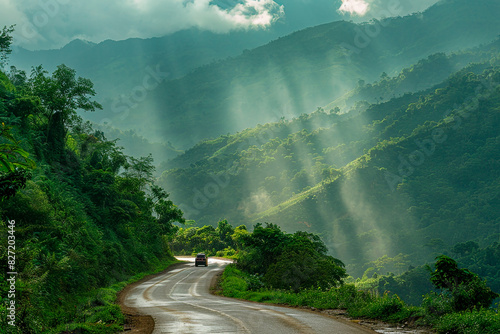 A car is driving down a road in the mountains photo