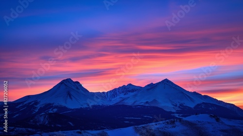 Vibrant twilight sky silhouetting a majestic  snow-capped mountain range