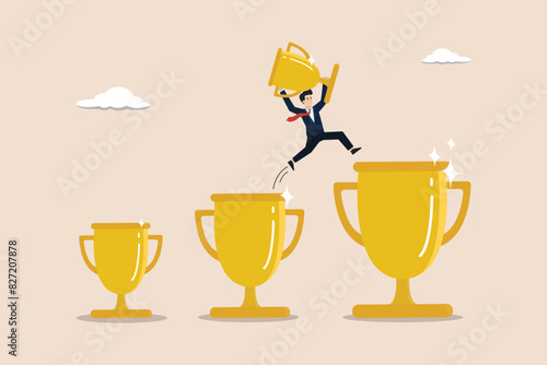 Win or achievement to motivate to achieve bigger goal, victory or win award concept, confident businessman jumping from small win trophy to get bigger one.