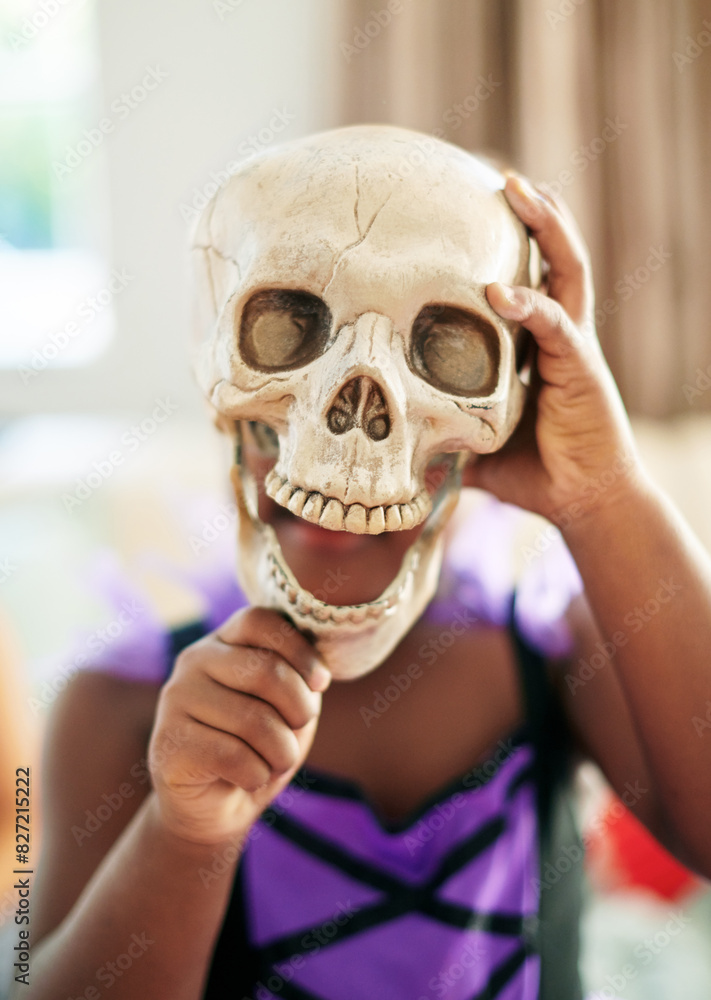 Child, costume and skull for halloween in home, celebrate with props for holiday with scary theme. Girl, living room and skeleton for party event with kids, crazy clothes for development in USA Child, costume and skull for halloween in home, celebrate with props for holiday with scary theme. Girl, living room and skeleton for party event with kids, crazy clothes for development in USA