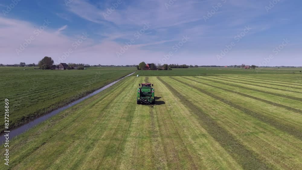 Harvesting Efficiency: Aerial Shot of Tractor Making Grass Bales Harvesting Efficiency: Aerial Shot of Tractor Making Grass Bales