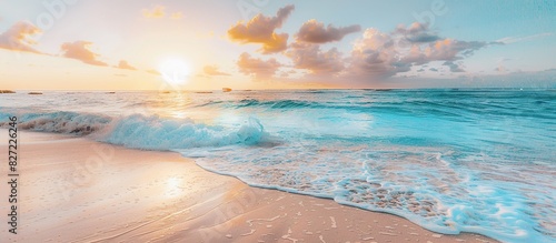 The ocean is calm and the sun is setting, creating a beautiful and serene atmosphere.