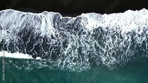 Horizontal Drone Shot of Black Sand Beach in Indonesia. Aerial View Top Down waves crushing photo