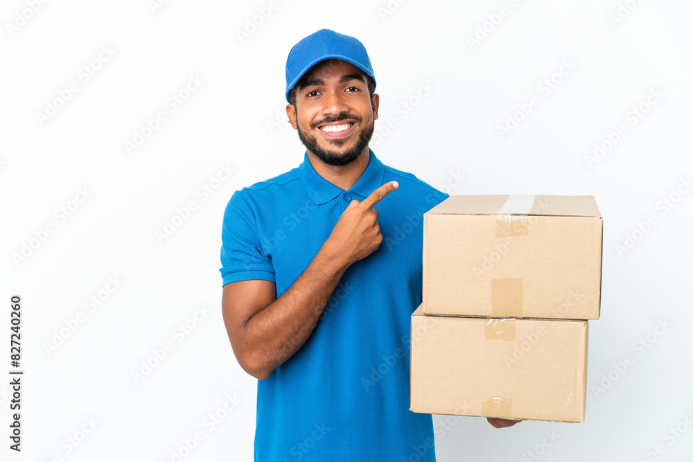 Delivery Ecuadorian man isolated on white background pointing to the side to present a product