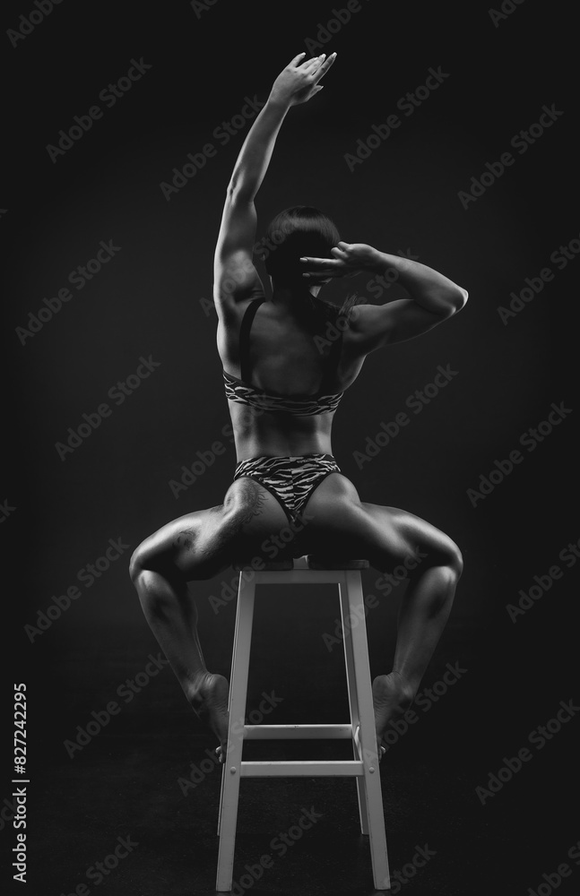 Black and white image of a sports woman in the studio. Beautiful body. Black and white image of a sports woman in the studio. Beautiful body.