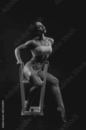 Black and white image of a sports woman in the studio. Beautiful body. © andy_gin