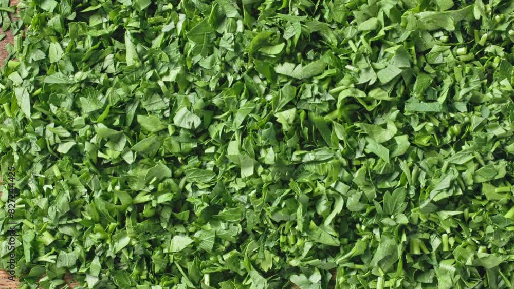 Fresh green chopped parsley background, top view, movement to the side. Close-up of food Fresh green chopped parsley background, top view, movement to the side. Close-up of food
