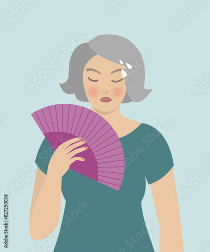 Woman cooling herself with fan, hot flashes, menopause symptoms.