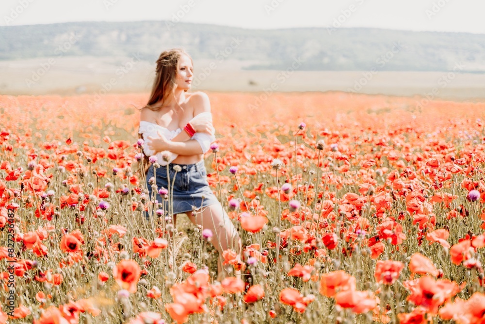 Woman poppies field. Side view of a happy woman with long hair in a poppy field and enjoying the beauty of nature in a warm summer day. Woman poppies field. Side view of a happy woman with long hair in a poppy field and enjoying the beauty of nature in a warm summer day.