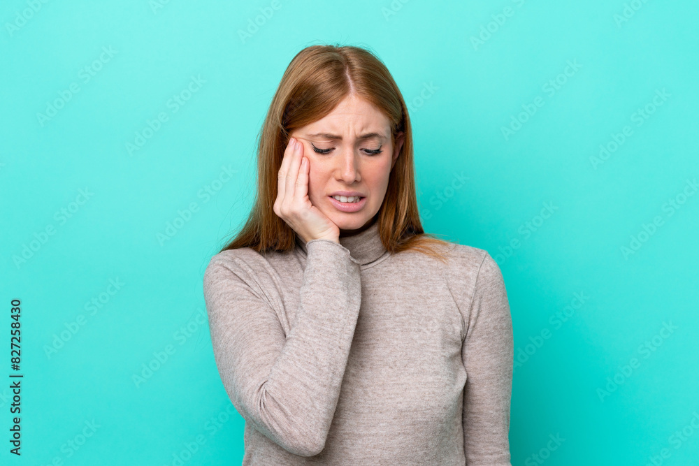Young redhead woman isolated on blue background with toothache Young redhead woman isolated on blue background with toothache