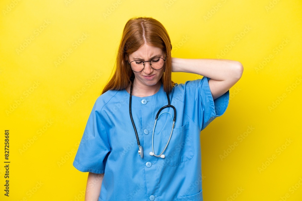 Young redhead nurse woman isolated on yellow background with neckache