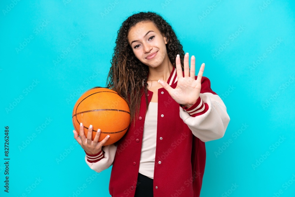 Arab basketball player woman isolated on blue background counting five with fingers Arab basketball player woman isolated on blue background counting five with fingers