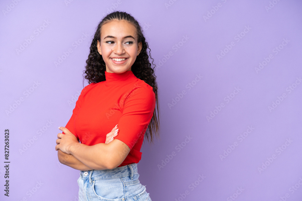 Young woman isolated on purple background with arms crossed and happy Young woman isolated on purple background with arms crossed and happy