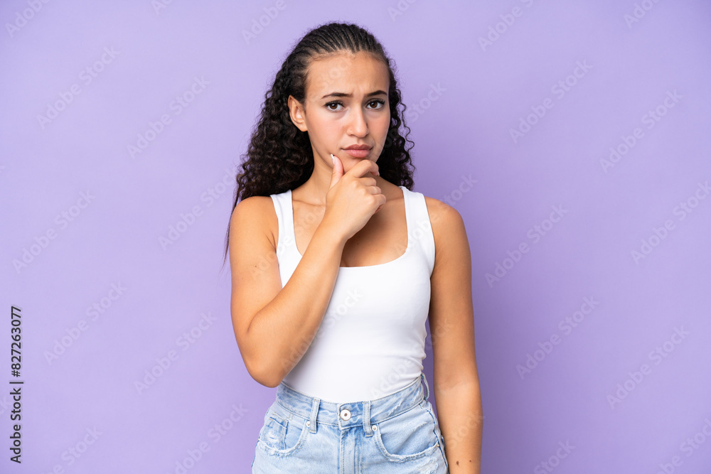 Young woman isolated on purple background having doubts Young woman isolated on purple background having doubts
