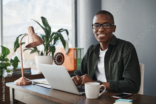 Black, businessman and smile with laptop in portrait for confidence and pride in freelance job. Happy, male person and copywriter with computer for writing blog, articles and email feedback in office