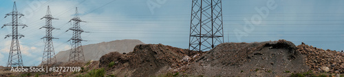 Industrial power Towers and lines releasing - industrial area with slag dumps from the production of iron ore. Location of the plant for the production of metal and purification of iron ore.
