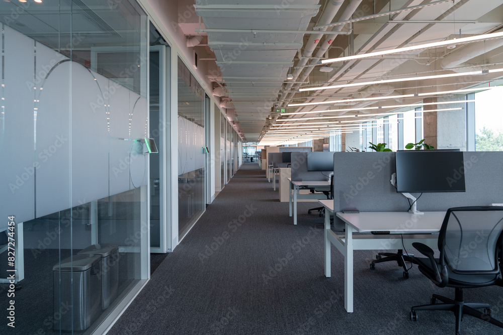 Interior of modern empty office building.Open ceiling design.Equipped with automatic lifting table and LCD screen. Interior of modern empty office building.Open ceiling design.Equipped with automatic lifting table and LCD screen.