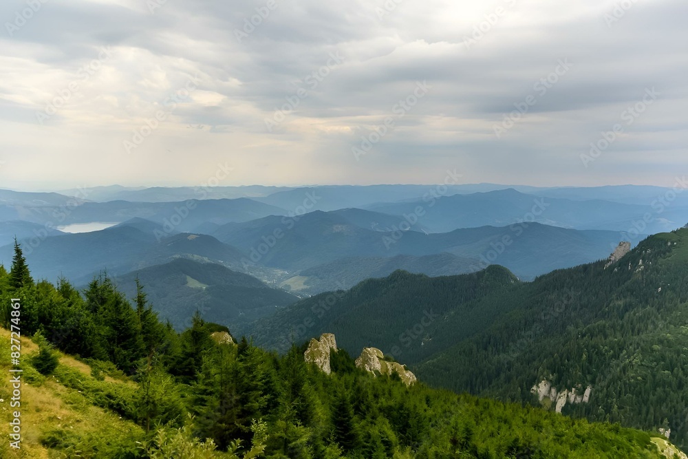 Fototapeta premium View of an open mountain valley with distant horizons in Ceahlau Mountain, Piatra Neamt, Romania
